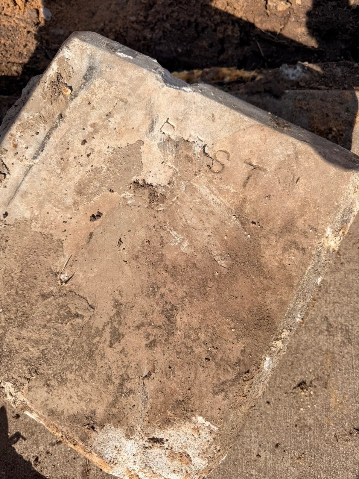 Faint lettering on a weathered stone