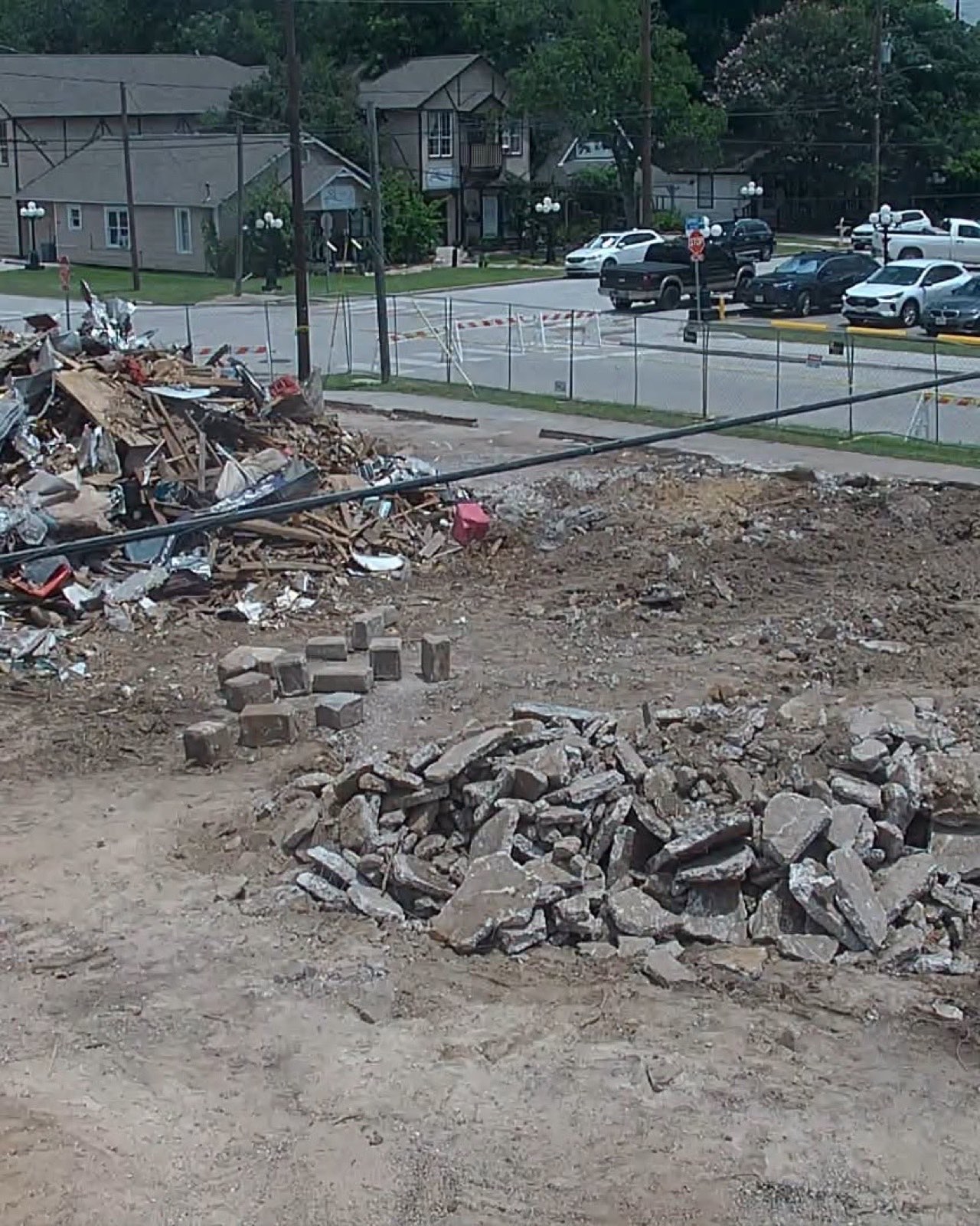 Broken stone and rubble on the cleared lot at Walnut and Commerce